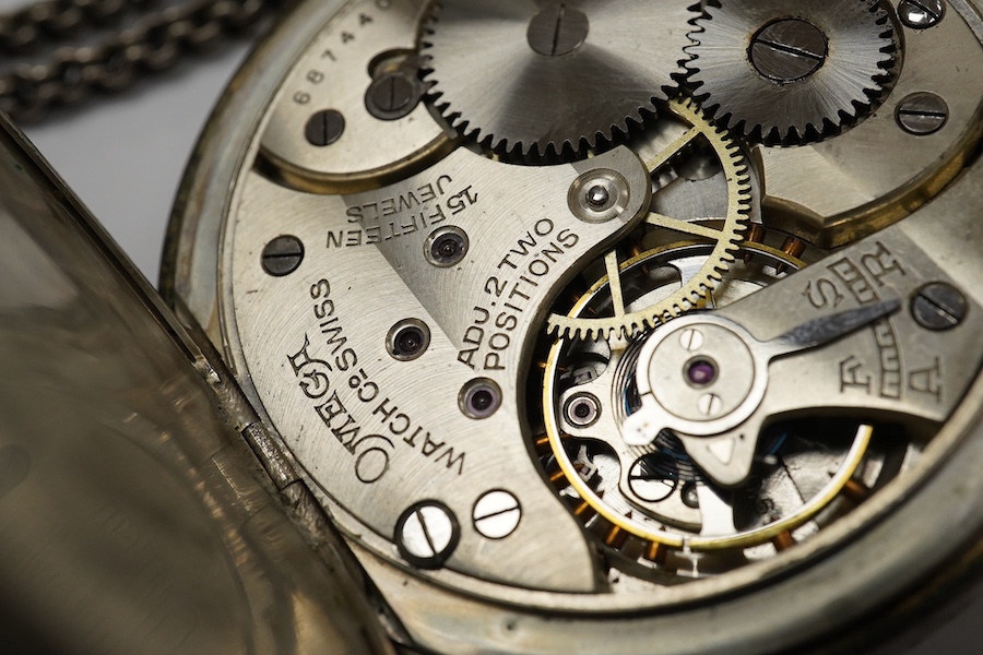 An 800 standard white metal Omega open faced keyless pocket watch, with Arabic dial and subsidiary seconds, case diameter 48mm, together with a white metal albertina. Condition - poor